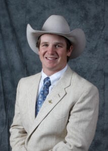 A man in a suit and cowboy hat.