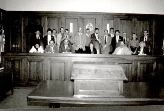 A group of people sitting in front of a judge.